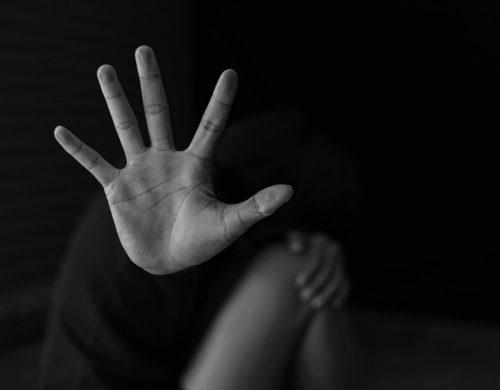 A black and white photo of a woman with her hand up showcasing bail bonds in Titusville.